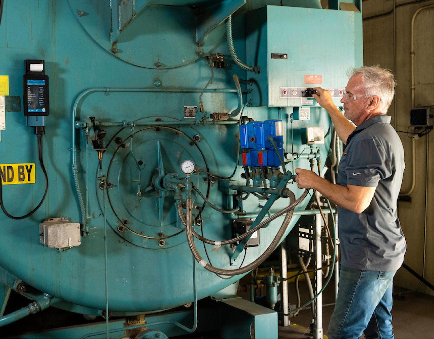 Service Tech managing a boiler Service Tech managing a boiler